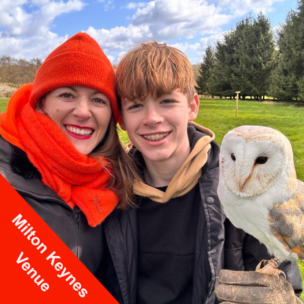 Image of Mother and son with Juliet (tyto alba) our barn owl on his fist. Taking part in a private falconry experience at Alders Farm near Milton Keynes